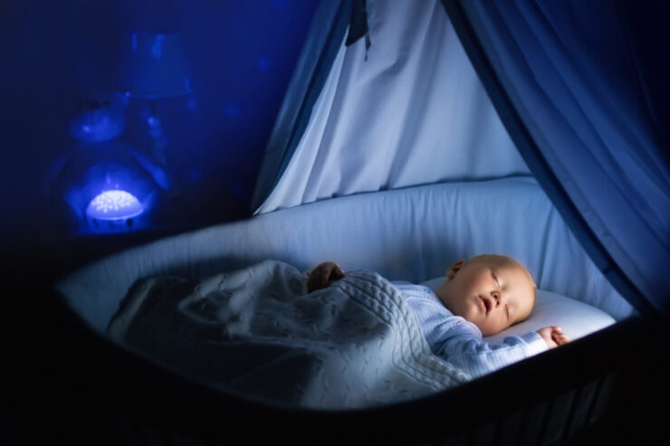 Baby boy drinking milk in bed